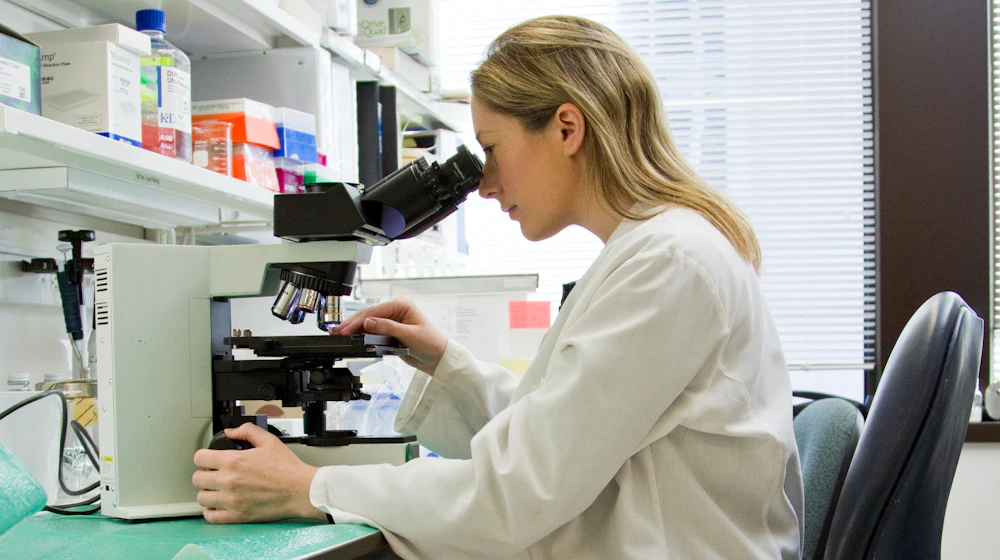 Researcher reviewing clinical trial data in a laboratory
